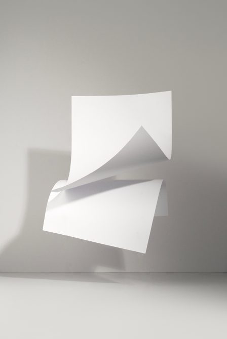 Clean white folded paper mockup stacked on neutral gray background